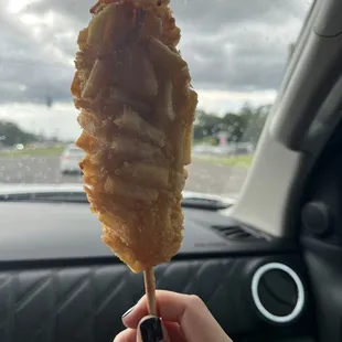 Potato corn dog. Top half is mozzarella cheese and bottom is hot dog.