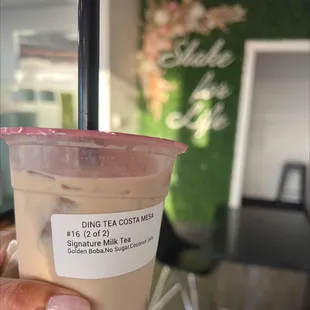 a hand holding a cup of coffee