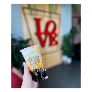 a hand holding a cup