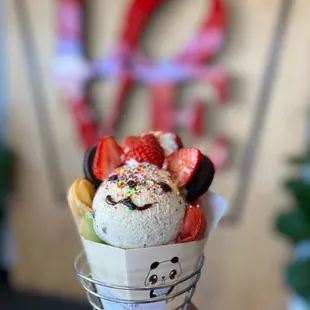 a hand holding a cone of ice cream