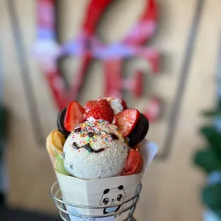 a hand holding a cone of ice cream