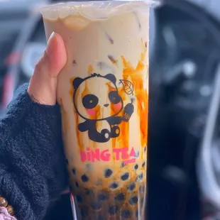 a person holding a cup of tea