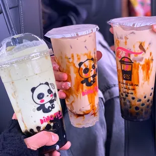 a person holding two drinks