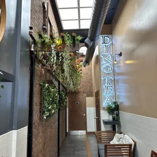 a hallway with benches and a sign