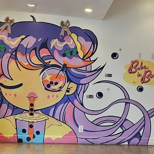 a wall mural of a girl with purple hair