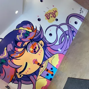 a mural of a woman with purple hair