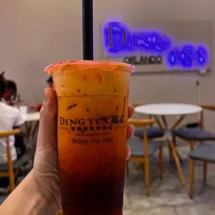 a person holding up a drink