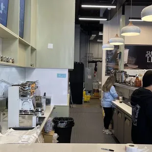 a woman standing in a coffee shop