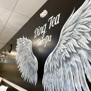 a mural of wings painted on a wall