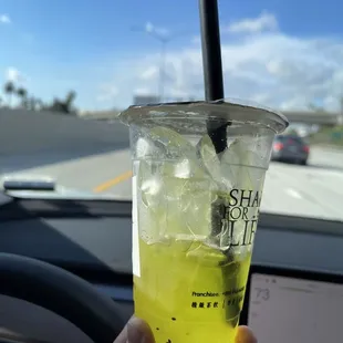 a person holding a drink in their hand