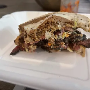 Half eaten pastrami on marble rye