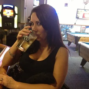a woman drinking a pint of beer
