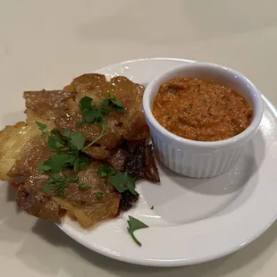 Crispy smashed potatoes with Romesco sauce