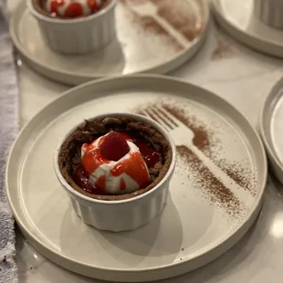 Flourless chocolate cake with whipped cream, and raspberry coulis.