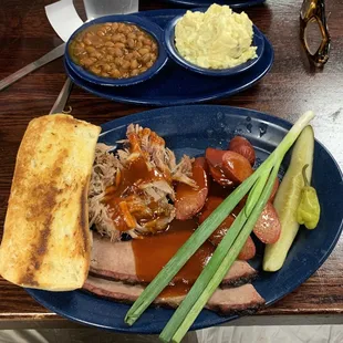 3 Meat Combination Plate with sliced brisket, pulled pork, extra hot sausage, sides of potato salad and baked beans plus buttery toast
