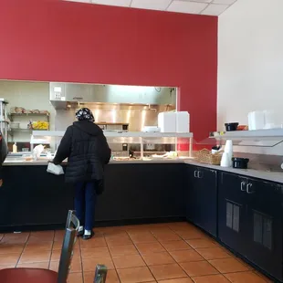 a woman standing in a restaurant kitchen