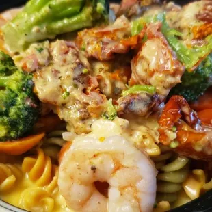 a bowl of pasta with shrimp and broccoli