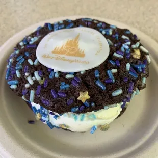 a chocolate donut with frosting and sprinkles