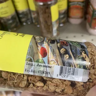 a hand holding a jar of food
