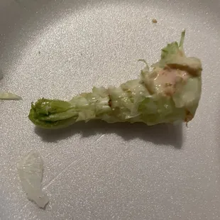 This was found in a hamburger. Looks trash from a lettuce. What I would consider trash &amp; don't think it belongs inside the hamburger.