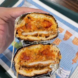 a hand holding a sandwich