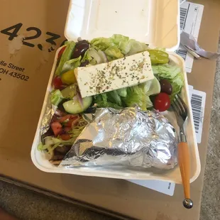 a salad in a styrofoam container