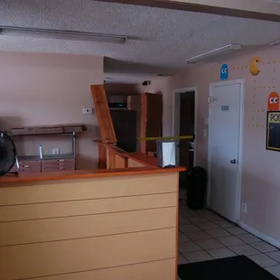 a kitchen with a bar and a fan