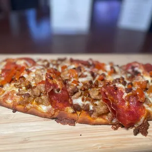 a pizza on a cutting board