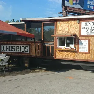 a food truck with a table and chairs