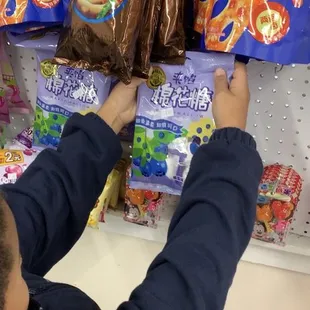 a boy reaching for snacks