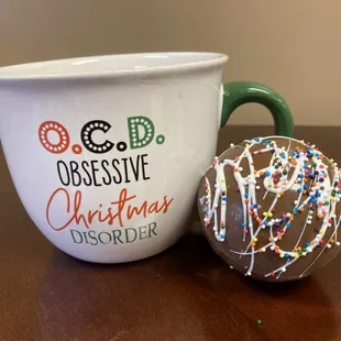 a cup and a doughnut on a table