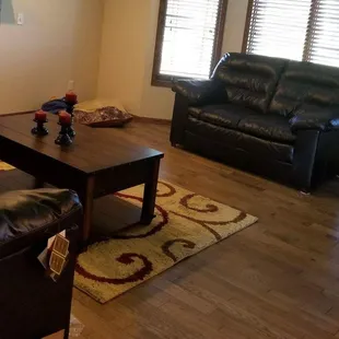 a living room with leather furniture