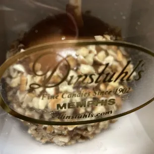 closeup view of a pecan-coated caramel apple