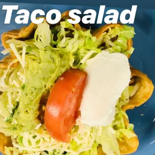 a taco salad on a blue plate