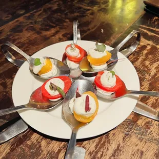a plate of desserts with spoons
