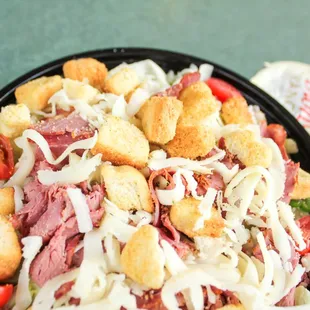 Ranch salad with iceberg lettuce, pastrami, provolone, tomatoes, croutons &amp; Dion's mix.