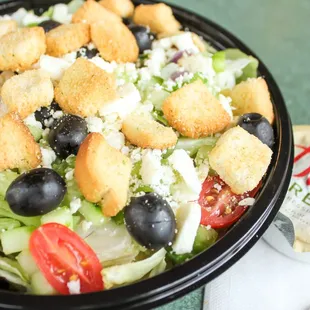 Greek salad with iceberg lettuce, black olives, feta, tomatoes, croutons &amp; Dion's mix.