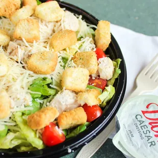 Chicken Caesar salad with romaine lettuce, chicken, tomatoes, croutons &amp; Parmesan.