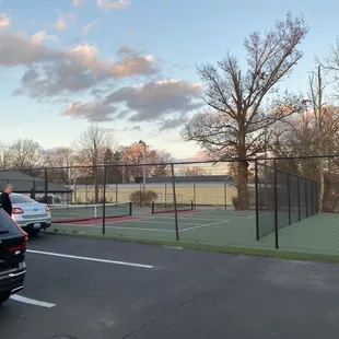a parking lot with a tennis court