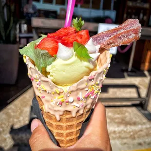 a hand holding an ice cream cone