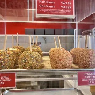 a variety of candy apples in a display case