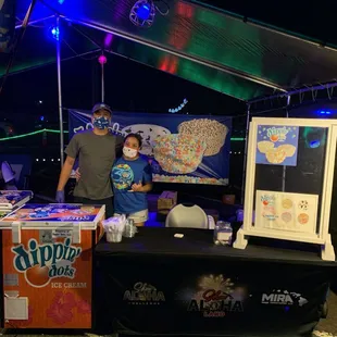  a man and a boy at a booth