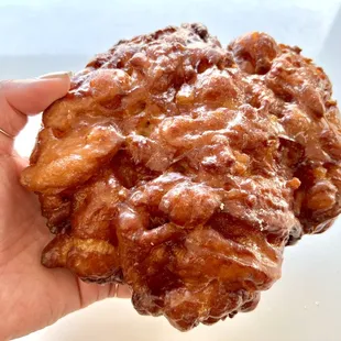 Apple fritter. Small bits of apples with sweet cinnamon syrup &amp; glazed. Crunchy fritter edges are the best. They&apos;re big so, share! Or not.