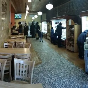 a man in a cape walking through a restaurant