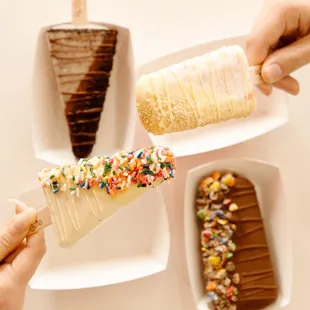 a person holding an ice cream cone with sprinkles