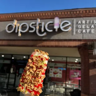 Strawberry Cheescake with strawberry syrup, pistachios, and waffle cone toppings!