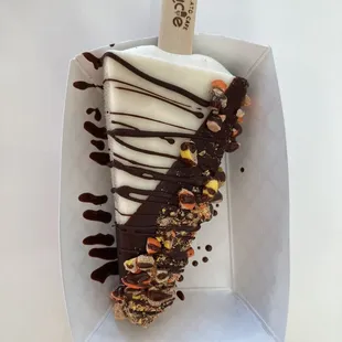 a piece of ice cream with chocolate drizzle