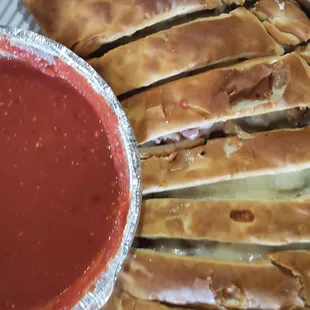 a box of pizza and a bowl of sauce