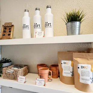 a shelf with various coffee bags and coffee mugs