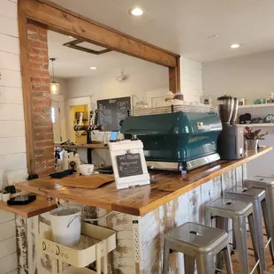 a green coffee machine on a counter